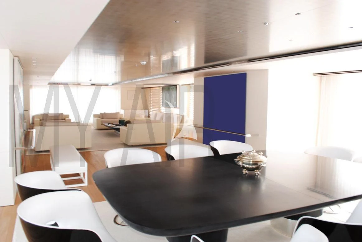 a room with a table and chairs aboard AIR Yacht for Sale