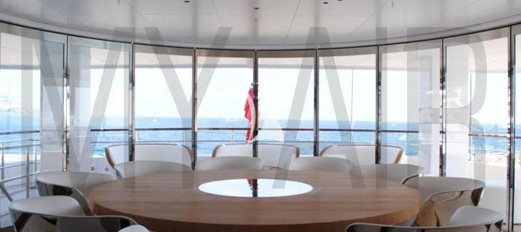 a room with tables and chairs aboard AIR Yacht for Sale