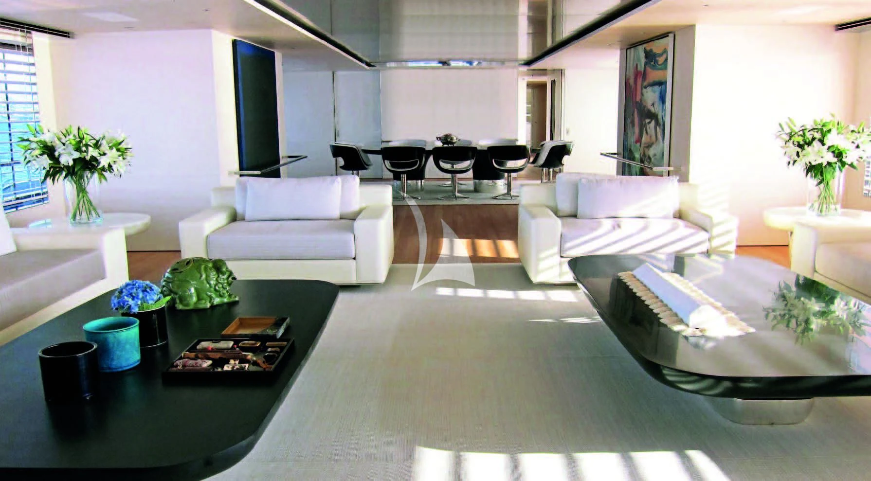 a living room with white couches and a table aboard AIR Yacht for Sale