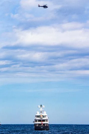 a helicopter flying over a boat in the ocean aboard AIR Yacht for Sale