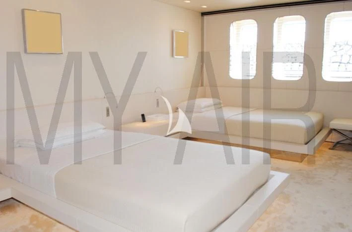 a room with a couch and a bed aboard AIR Yacht for Sale
