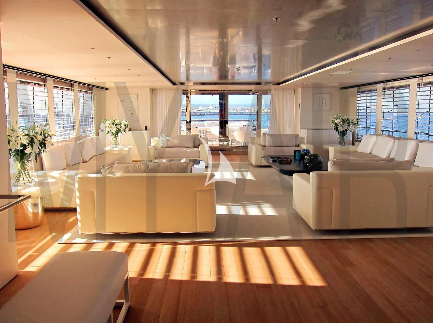 a room with a couch and a table aboard AIR Yacht for Sale