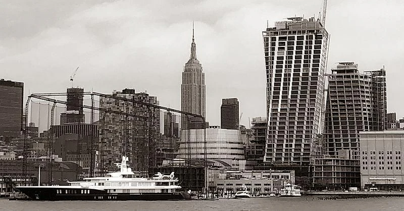 a city skyline with a boat aboard AIR Yacht for Sale