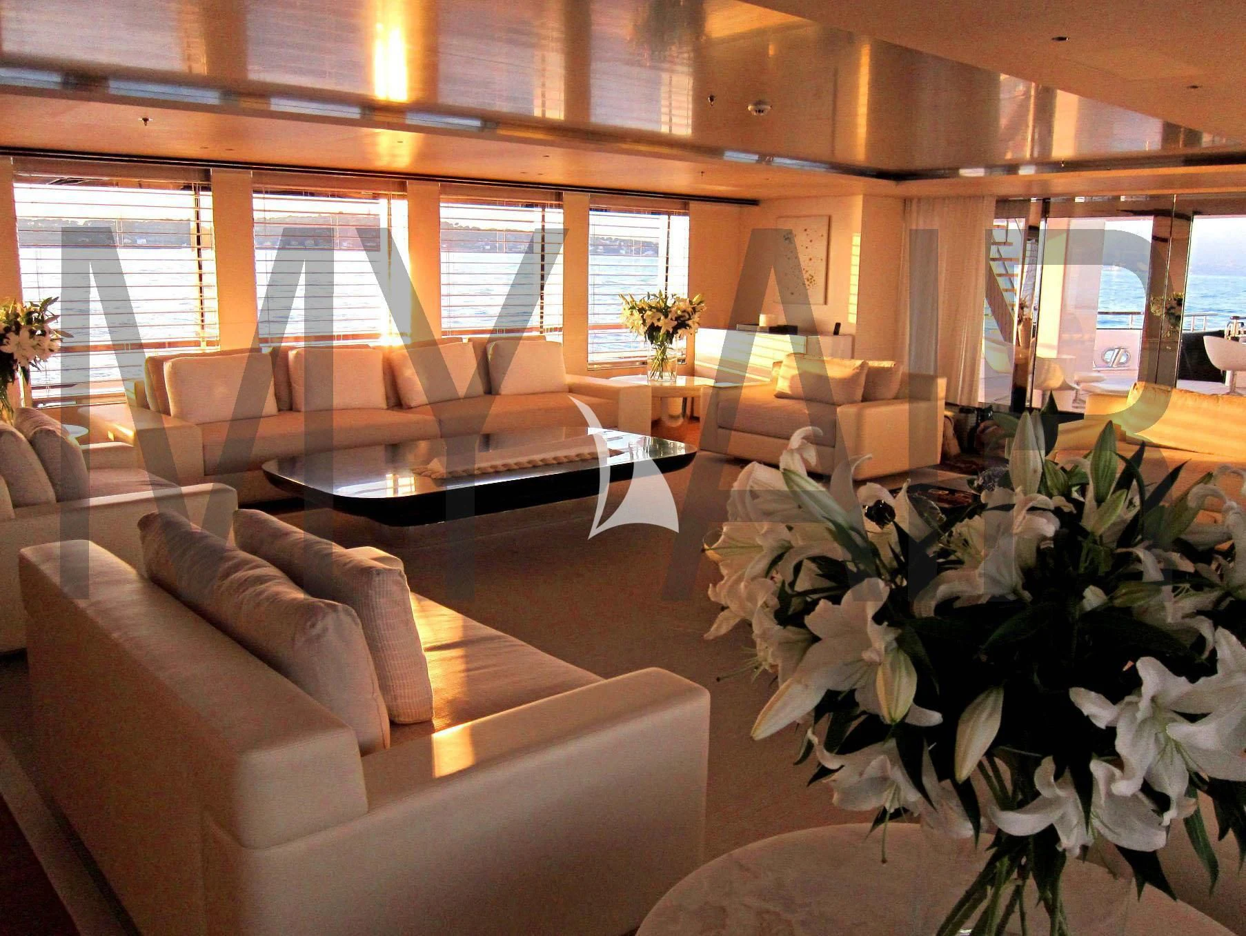 a room with couches and a table aboard AIR Yacht for Sale