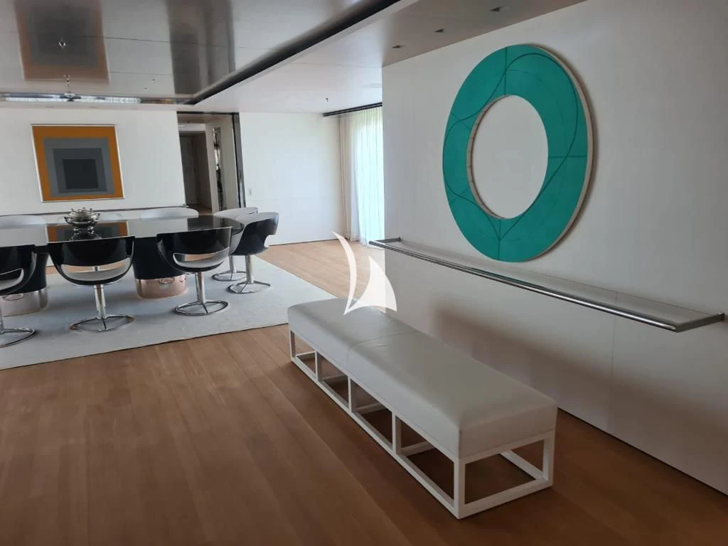 a room with a table and chairs aboard AIR Yacht for Sale