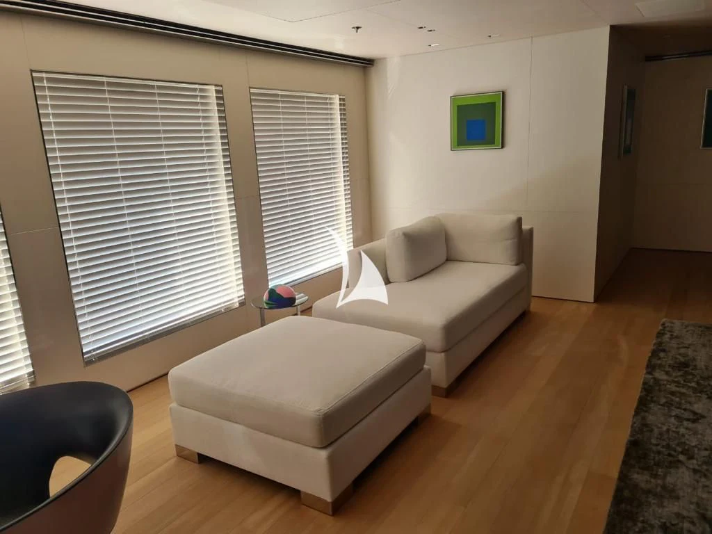 a living room with a couch and a window aboard AIR Yacht for Sale