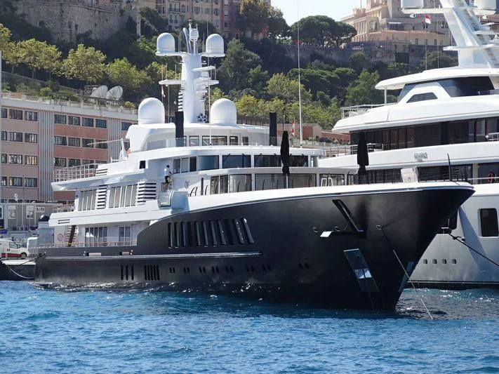 a large boat docked at a pier aboard AIR Yacht for Sale