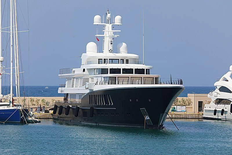 a large boat docked at a pier aboard AIR Yacht for Sale