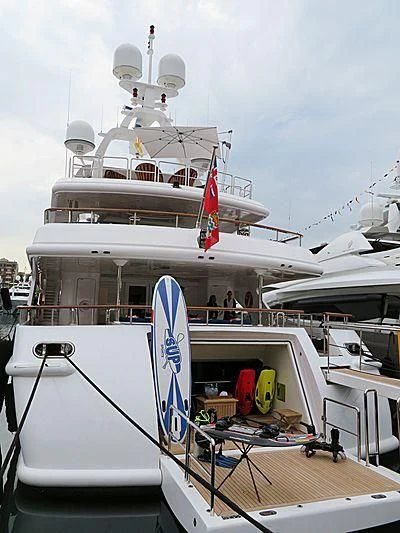 a large white boat with a blue and red flag on it aboard AIR Yacht for Sale