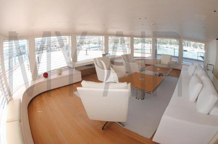 a room with a table chairs and a couch aboard AIR Yacht for Sale
