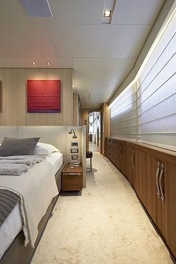 a bedroom with a bed and a desk aboard GI1 Yacht for Sale