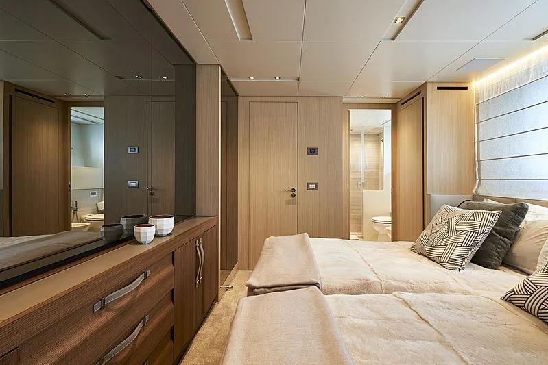 a bedroom with a bed and a mirror aboard GI1 Yacht for Sale