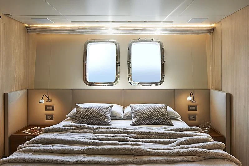 a bed with a large mirror above it aboard GI1 Yacht for Sale