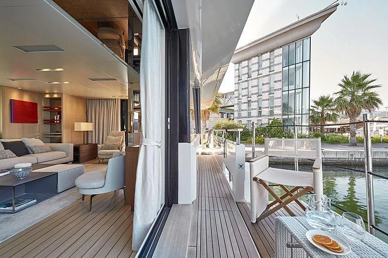 a balcony with a table and chairs aboard GI1 Yacht for Sale