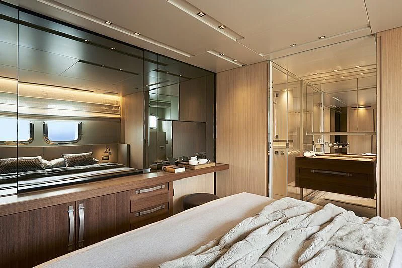 a bedroom with a bed and a desk aboard GI1 Yacht for Sale