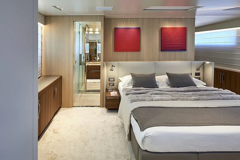 a bedroom with a bed and a desk aboard GI1 Yacht for Sale