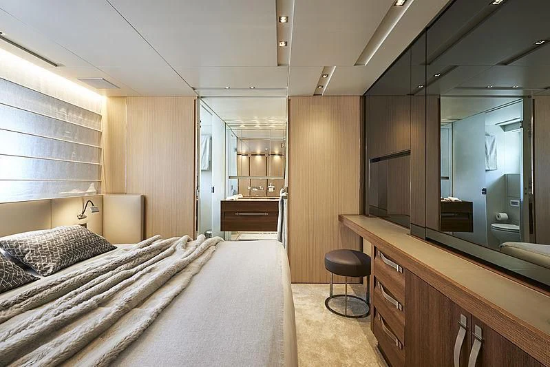 a bedroom with a bed and a desk aboard GI1 Yacht for Sale