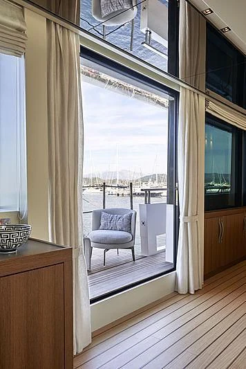 a room with a chair and a window aboard GI1 Yacht for Sale