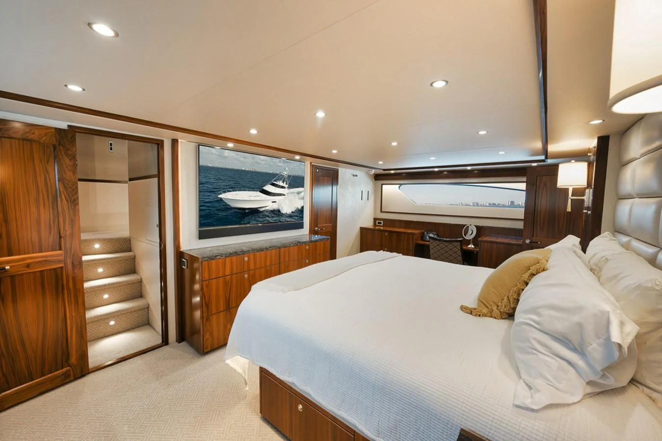 a bedroom with a bed and a wood cabinet aboard BELLA DONNA DI Yacht for Sale