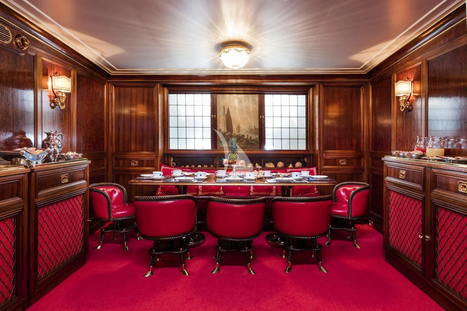 a large room with red chairs and a table with red chairs aboard CROCE DEL SUD Yacht for Sale