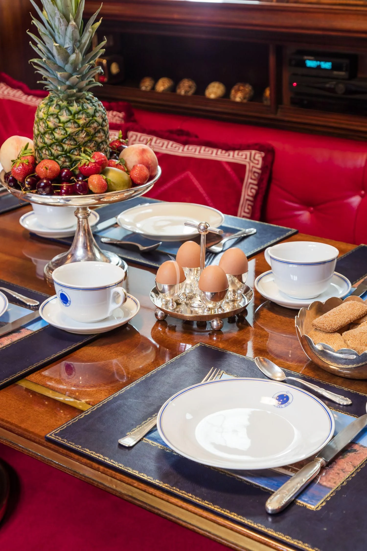 a table with plates and food on it aboard CROCE DEL SUD Yacht for Sale