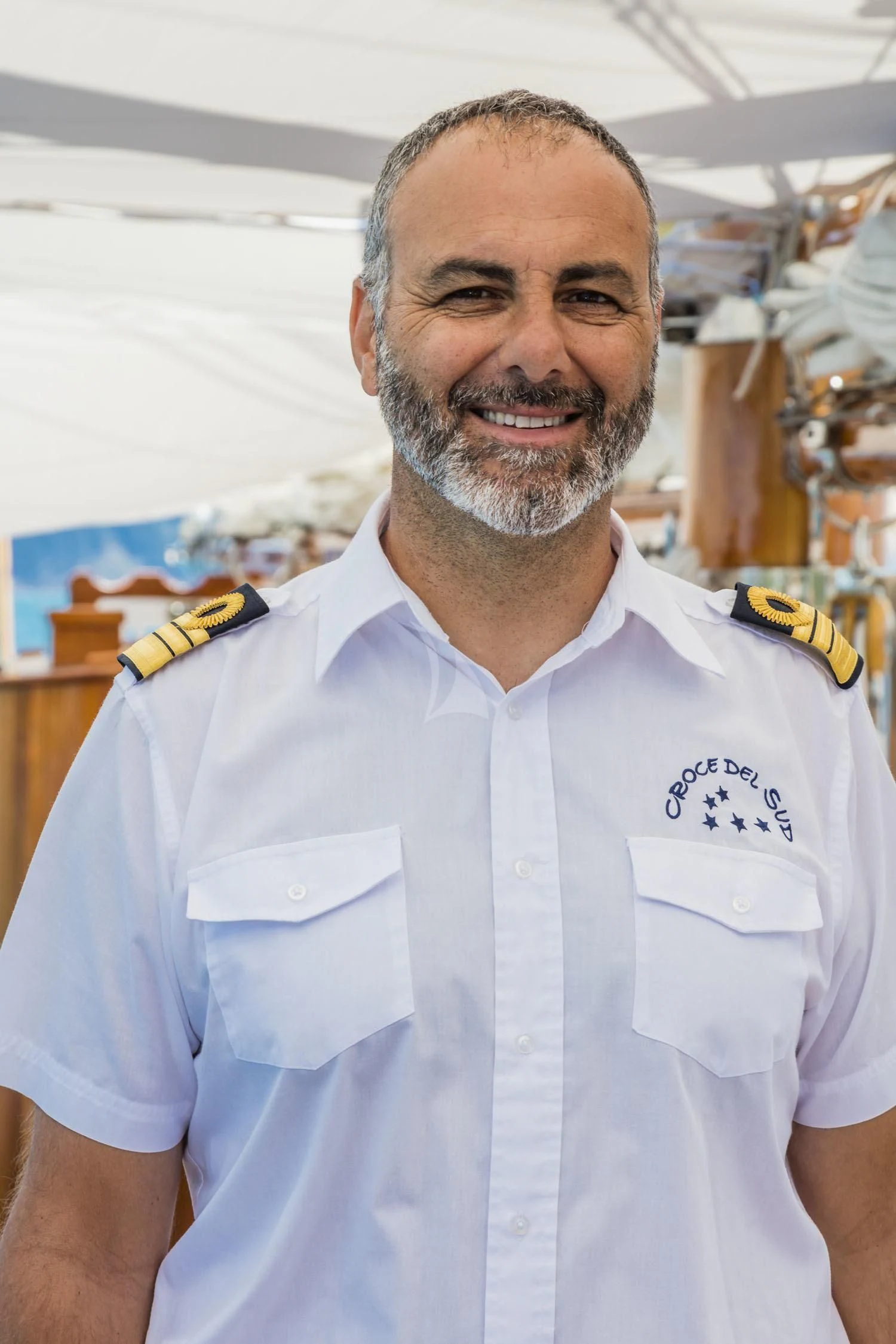 a man wearing a white shirt aboard CROCE DEL SUD Yacht for Sale