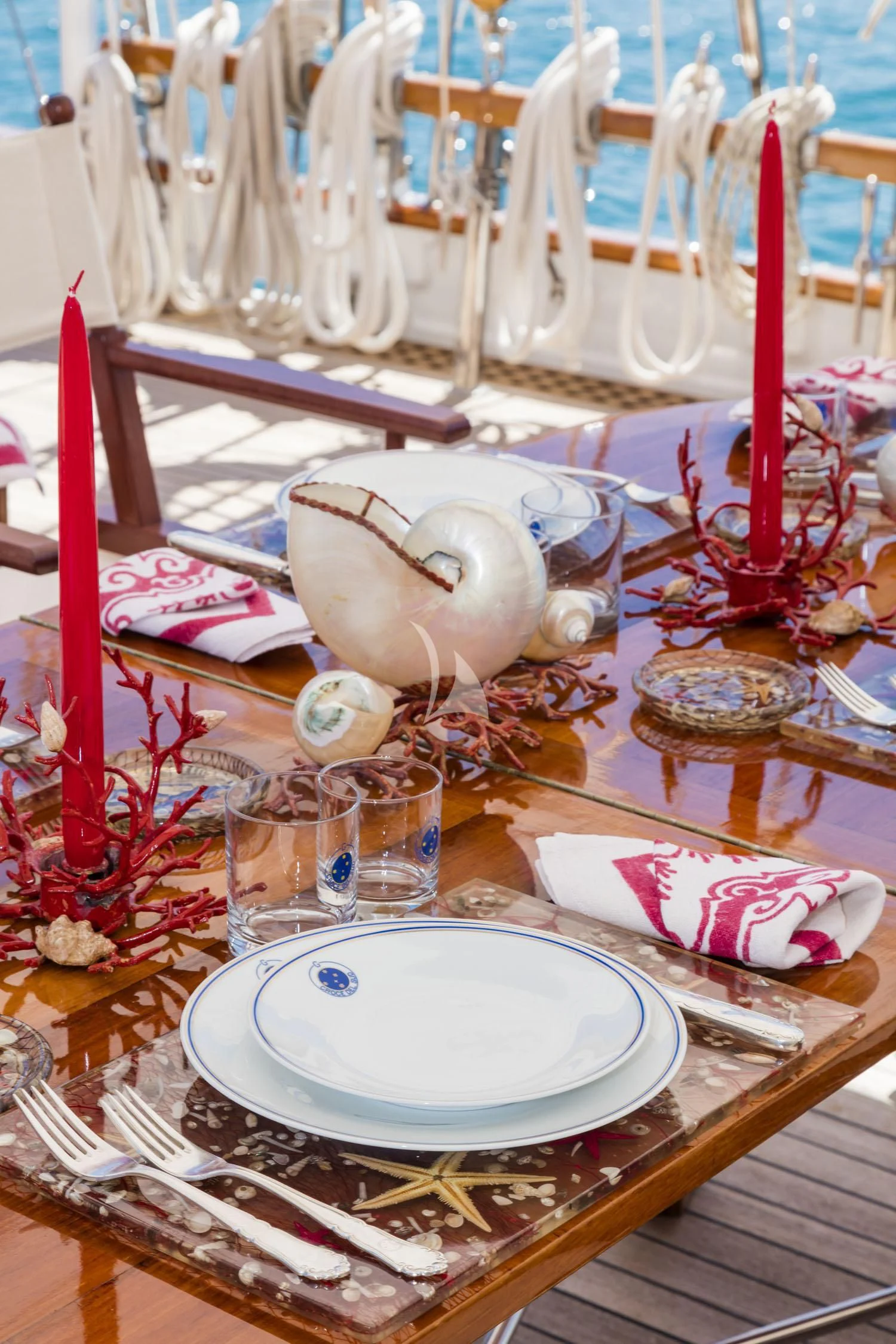 a table with plates and glasses aboard CROCE DEL SUD Yacht for Sale