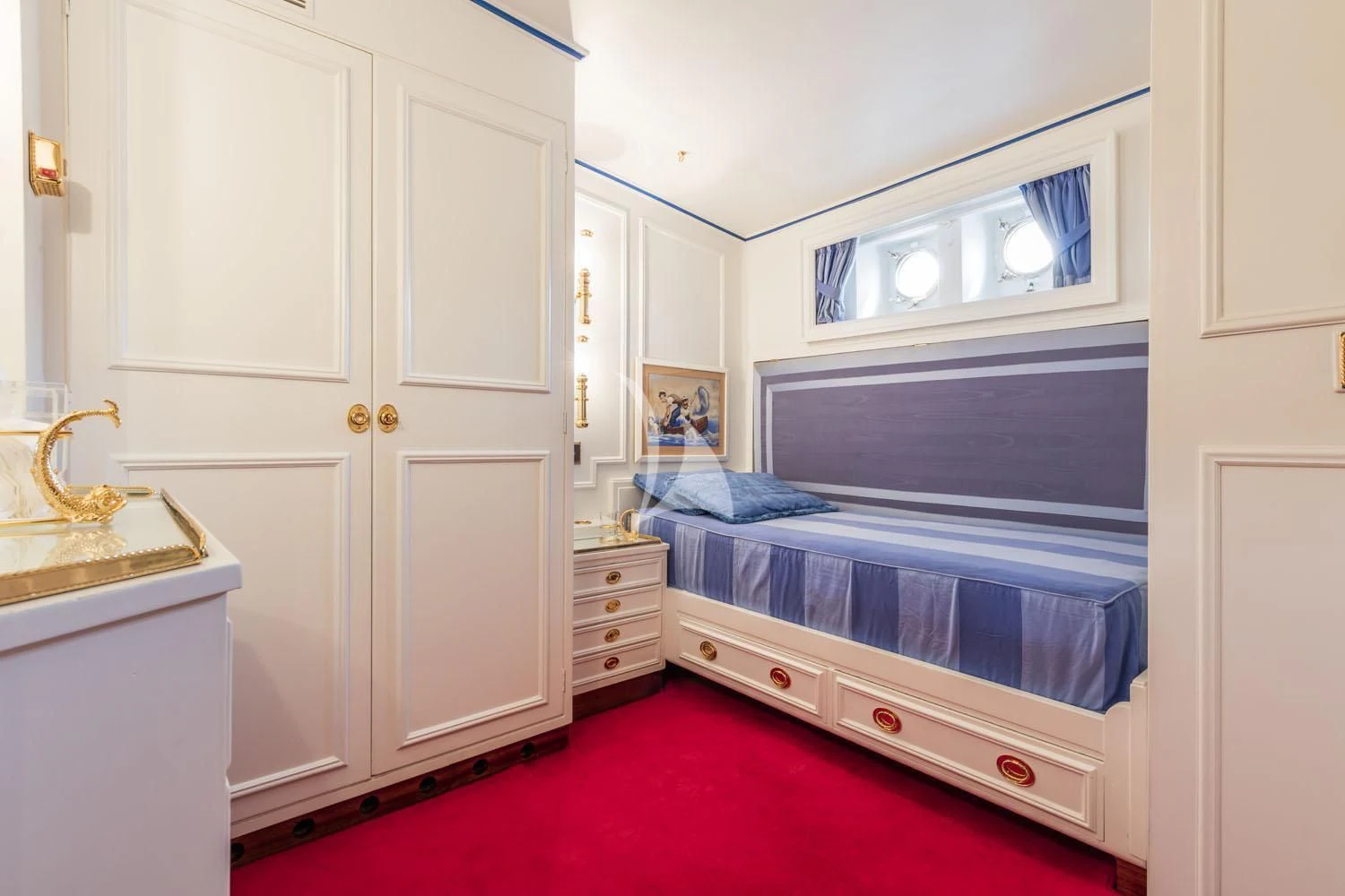 a bedroom with a red rug aboard CROCE DEL SUD Yacht for Sale