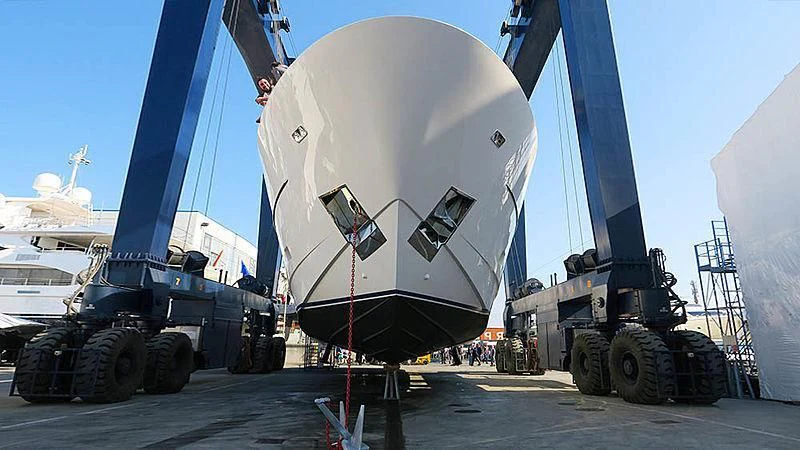 a large military vehicle parked in a port aboard THE MAGGIE Yacht for Sale