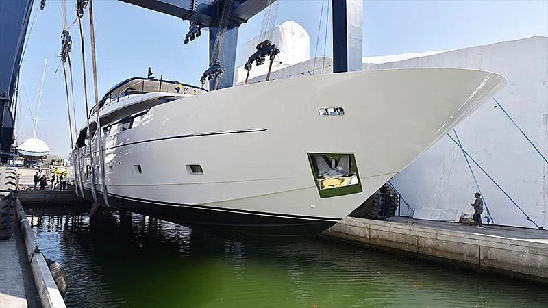 a large white boat with a person standing on the side aboard THE MAGGIE Yacht for Sale