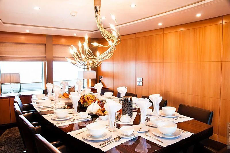 a dining room with a chandelier aboard GLORIA TERESA Yacht for Sale