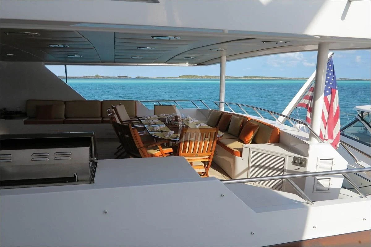 a boat with chairs and tables on the deck aboard LE MONTRACHET Yacht for Sale