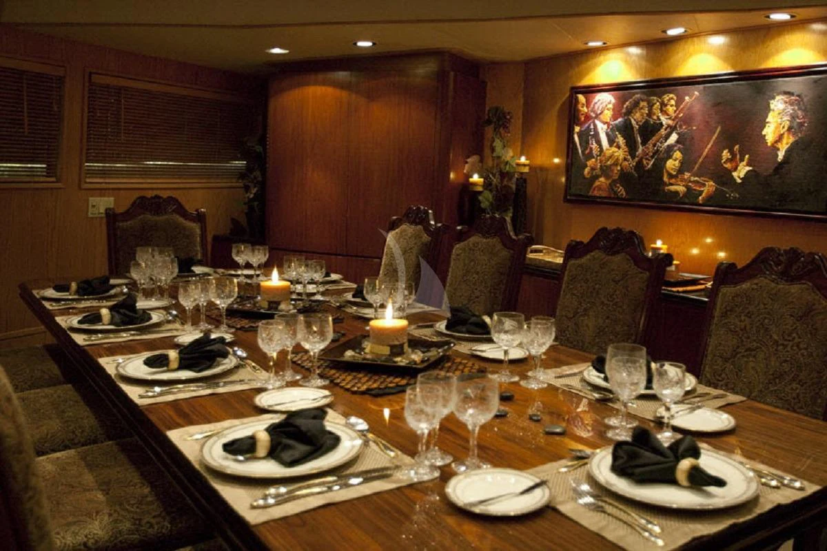 a table with plates and glasses aboard LE MONTRACHET Yacht for Sale