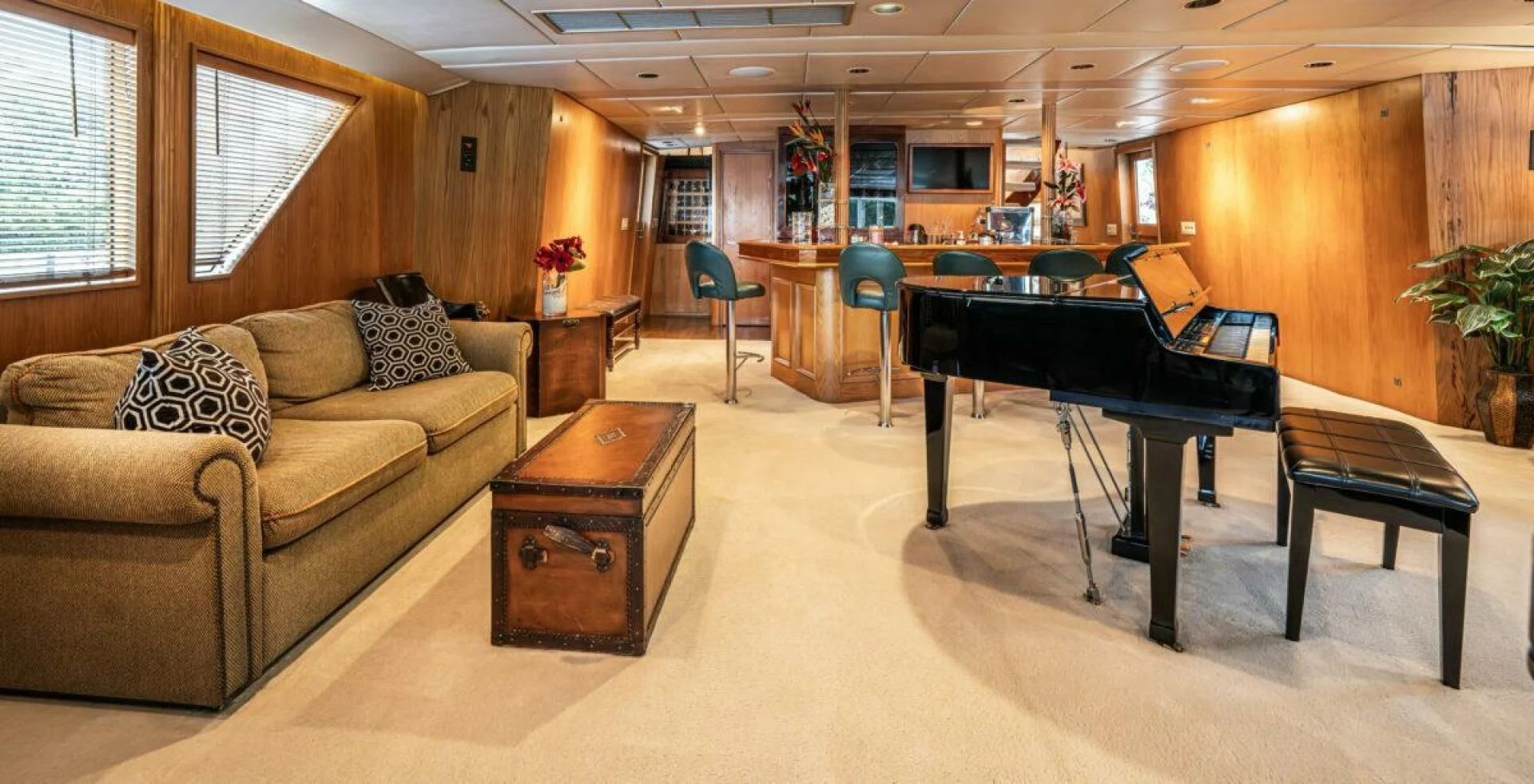 a living room with a piano and a couch aboard LE MONTRACHET Yacht for Sale