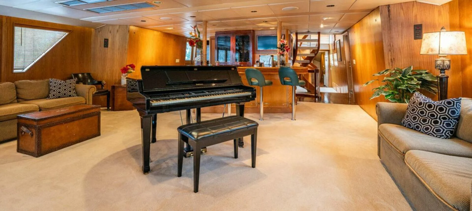 a living room with a piano and a couch aboard LE MONTRACHET Yacht for Sale