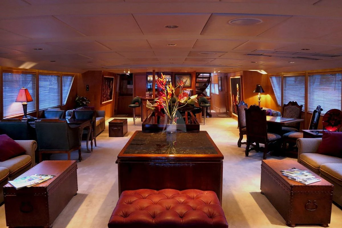 a living room with a table and couches aboard LE MONTRACHET Yacht for Sale