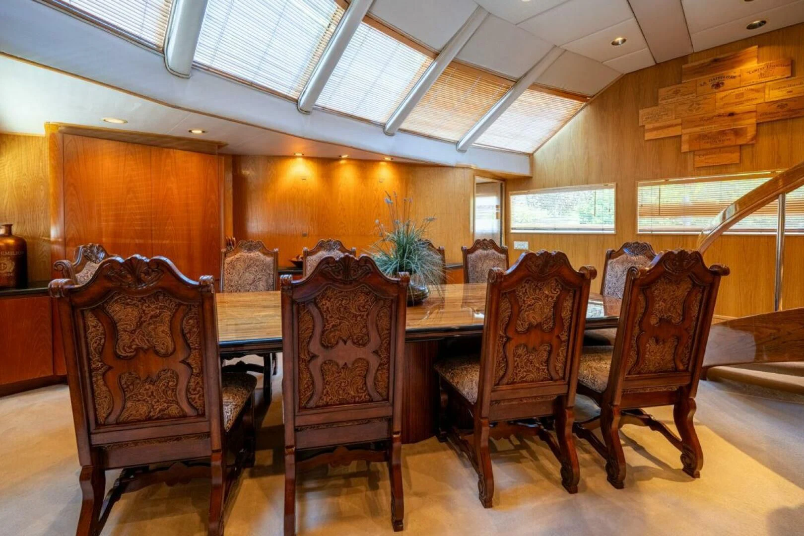 a dining room with wood furniture aboard LE MONTRACHET Yacht for Sale