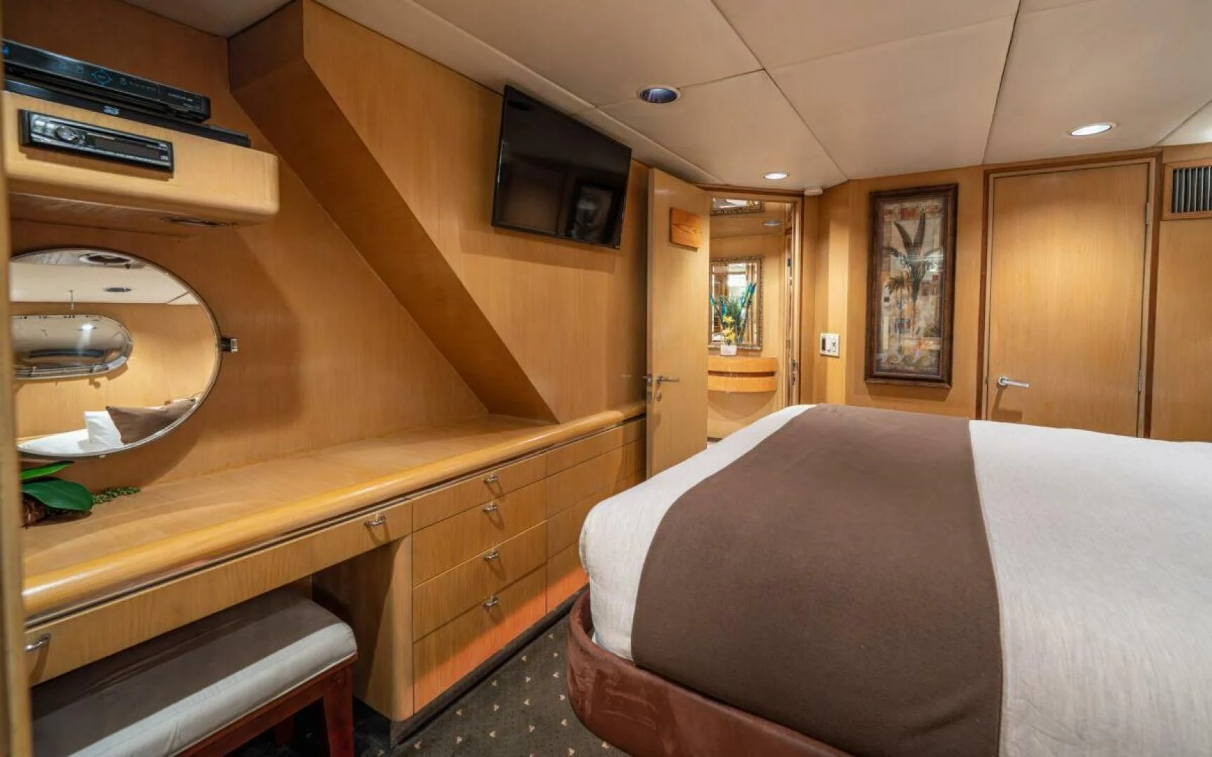 a room with a bed and a mirror aboard LE MONTRACHET Yacht for Sale