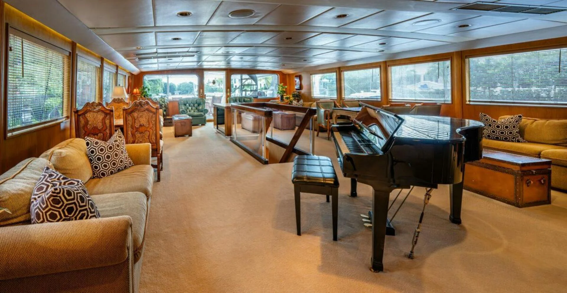 a large room with a couch and a table and chairs aboard LE MONTRACHET Yacht for Sale