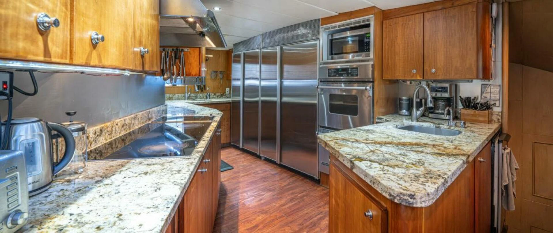 a kitchen with a marble counter top aboard LE MONTRACHET Yacht for Sale