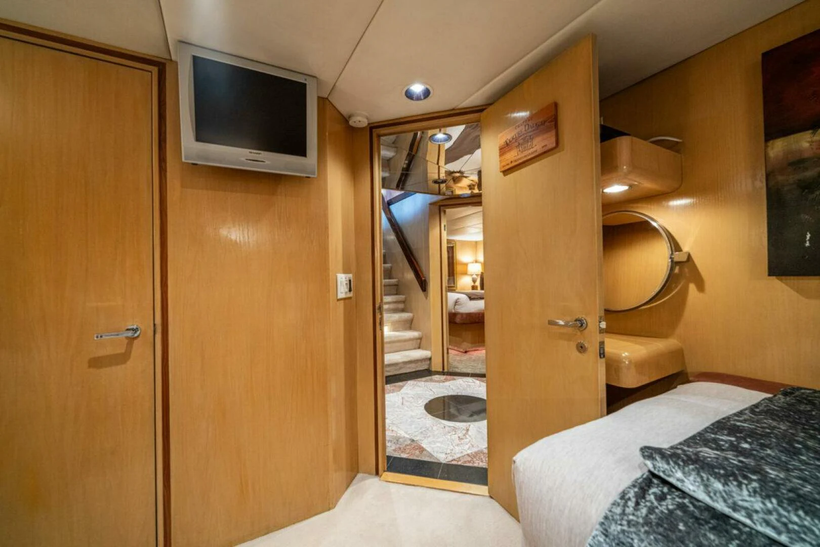 a room with a bed and a television aboard LE MONTRACHET Yacht for Sale