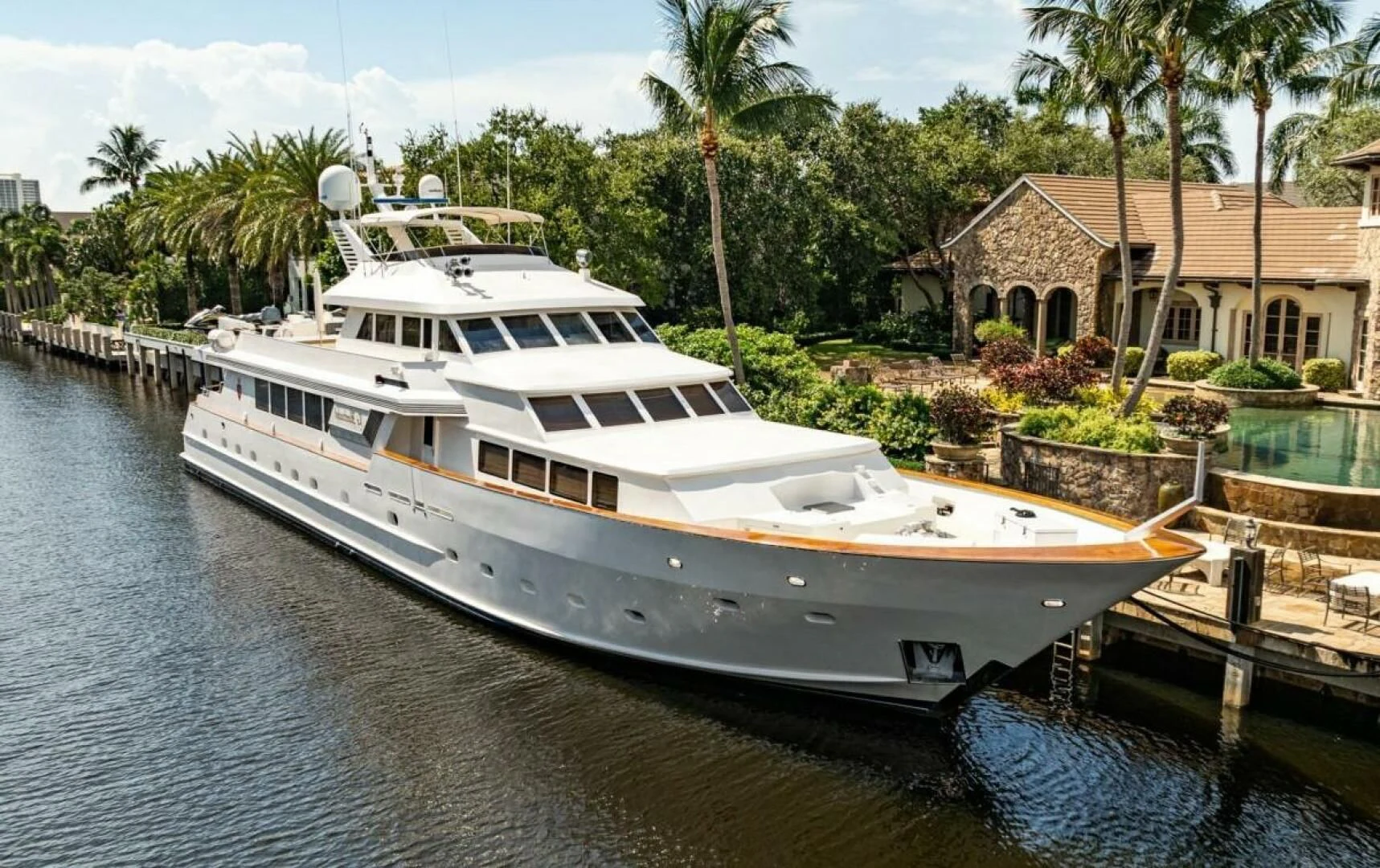 a large white boat sits at the dock aboard LE MONTRACHET Yacht for Sale
