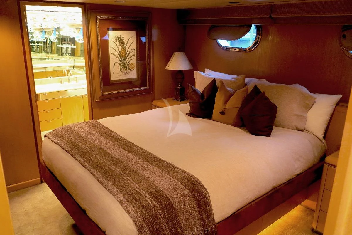 a bed with a white comforter aboard LE MONTRACHET Yacht for Sale