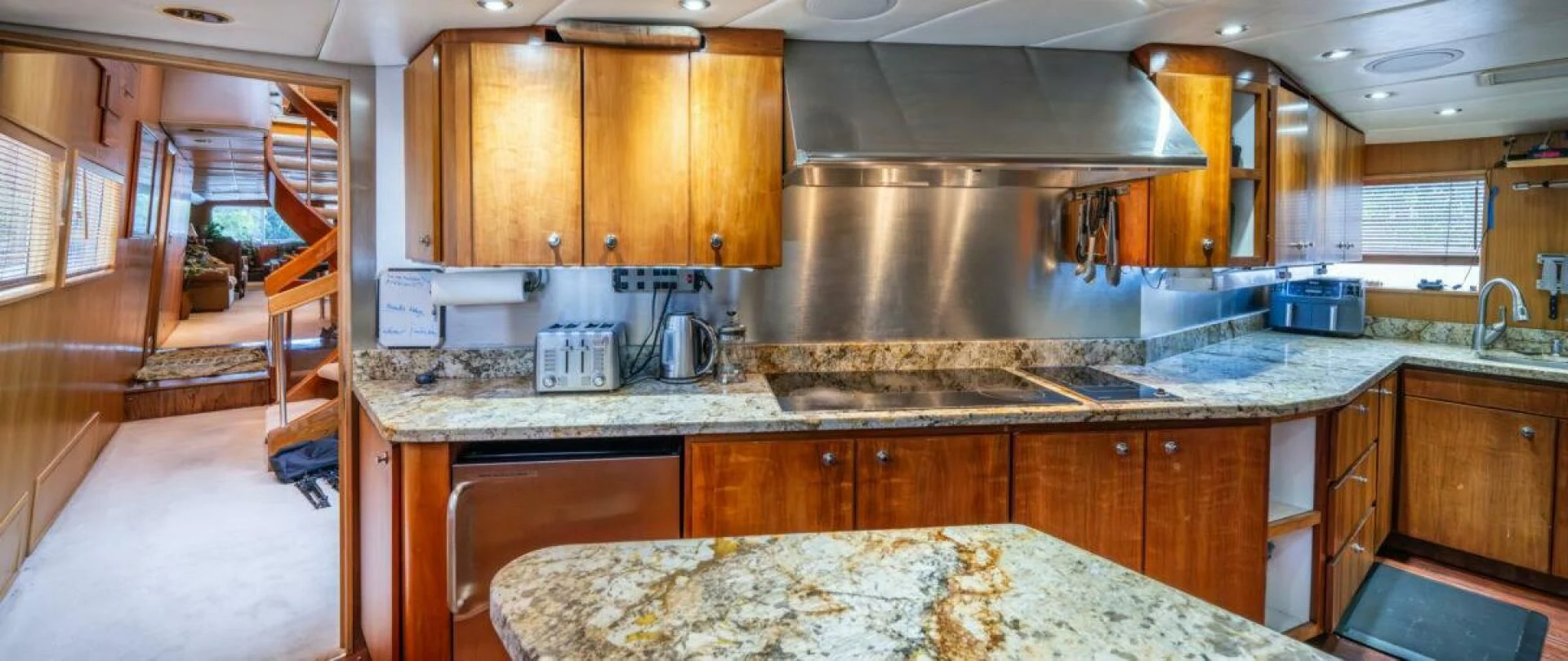 a kitchen with wooden cabinets aboard LE MONTRACHET Yacht for Sale