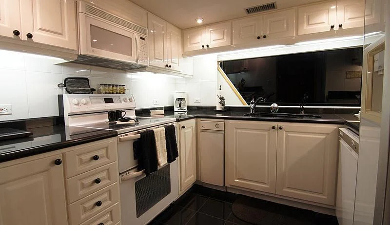 a kitchen with white cabinets aboard POOR RICHARD Yacht for Sale