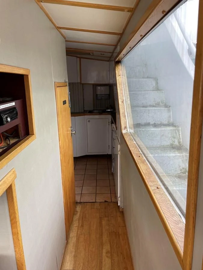 a kitchen with a stone wall aboard MAGIC MOMENT Yacht for Sale