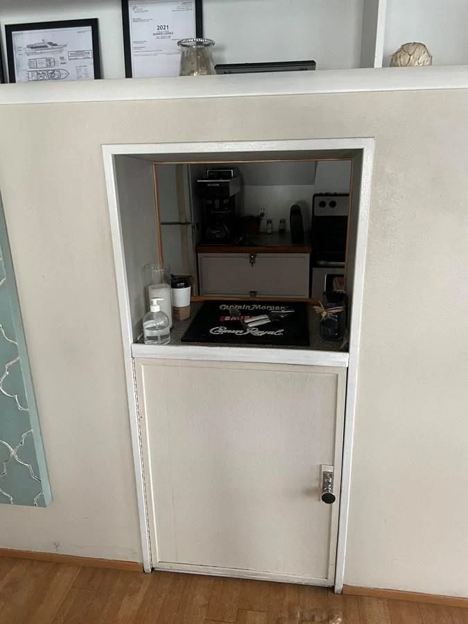 a white cabinet with a black stove aboard MAGIC MOMENT Yacht for Sale