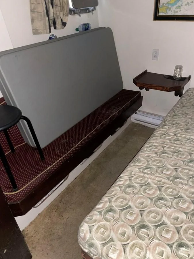 a bed with a black frame aboard MAGIC MOMENT Yacht for Sale