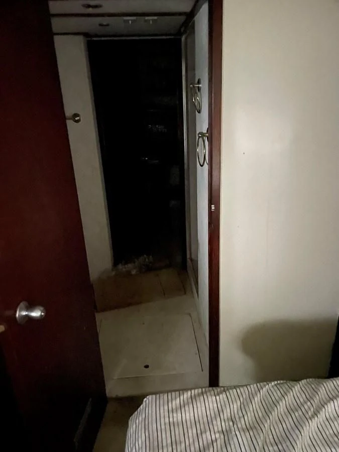 a hallway with a red door aboard MAGIC MOMENT Yacht for Sale