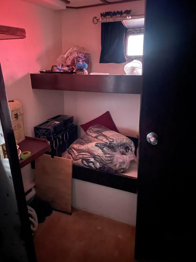 a small bedroom with a bed aboard MAGIC MOMENT Yacht for Sale